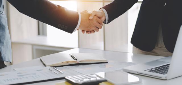 Handshake Over Desk